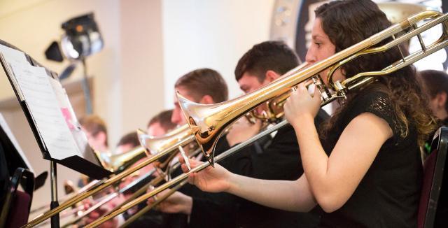 Longwood student playing the trombone in holiday concert performance