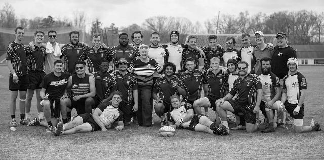 Ellie Miller stands with the 2018 Longwood men’s rugby team at the annual Todd Miller Memorial Rugby Tournament. Miller presented two players—a male and female rugger—with the newly endowed Todd Miller scholarship.