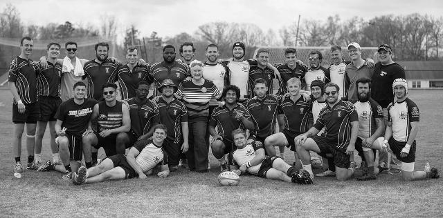 Ellie Miller stands with the 2018 Longwood men’s rugby team at the annual Todd Miller Memorial Rugby Tournament. Miller presented two players—a male and female rugger—with the newly endowed Todd Miller scholarship.