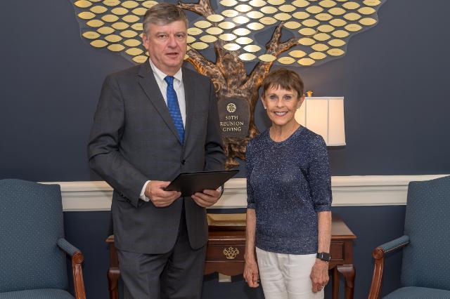 Farmville Mayor David Whitus '83 presents Joan Perry Brock '64 with a resolution honoring her philanthropic efforts and commitment to Farmville.