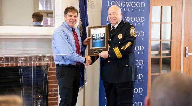 Vice President for Student Affairs Tim Pierson (left) presents a plaque to LUPD Chief Bob Beach recognizing the department’s ninth straight year of making the Security Magazine’s list of top university police departments in the country.