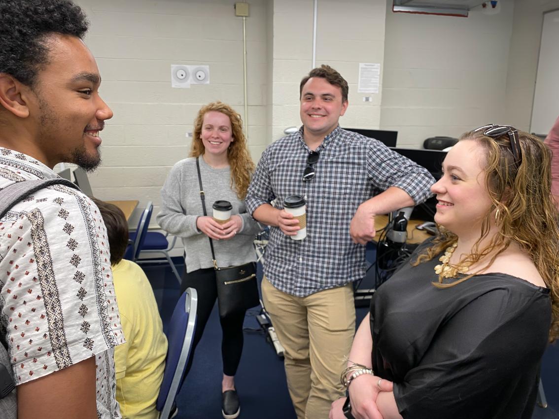 Josh Mealy ’24 (left) and Katie Boesel ’23 (right) chat with Bridgett Burg ’18 and Tyler Jones ’18 after their team’s final presentation on the Fictionary Dictionary project. Mealy served as the technical writer and Boesel as product owner; Burg and Jones worked with the team as clients.