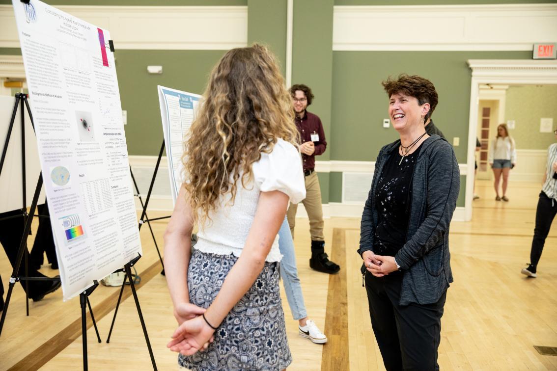 Dr. Michelle Parry talks with a student about her research