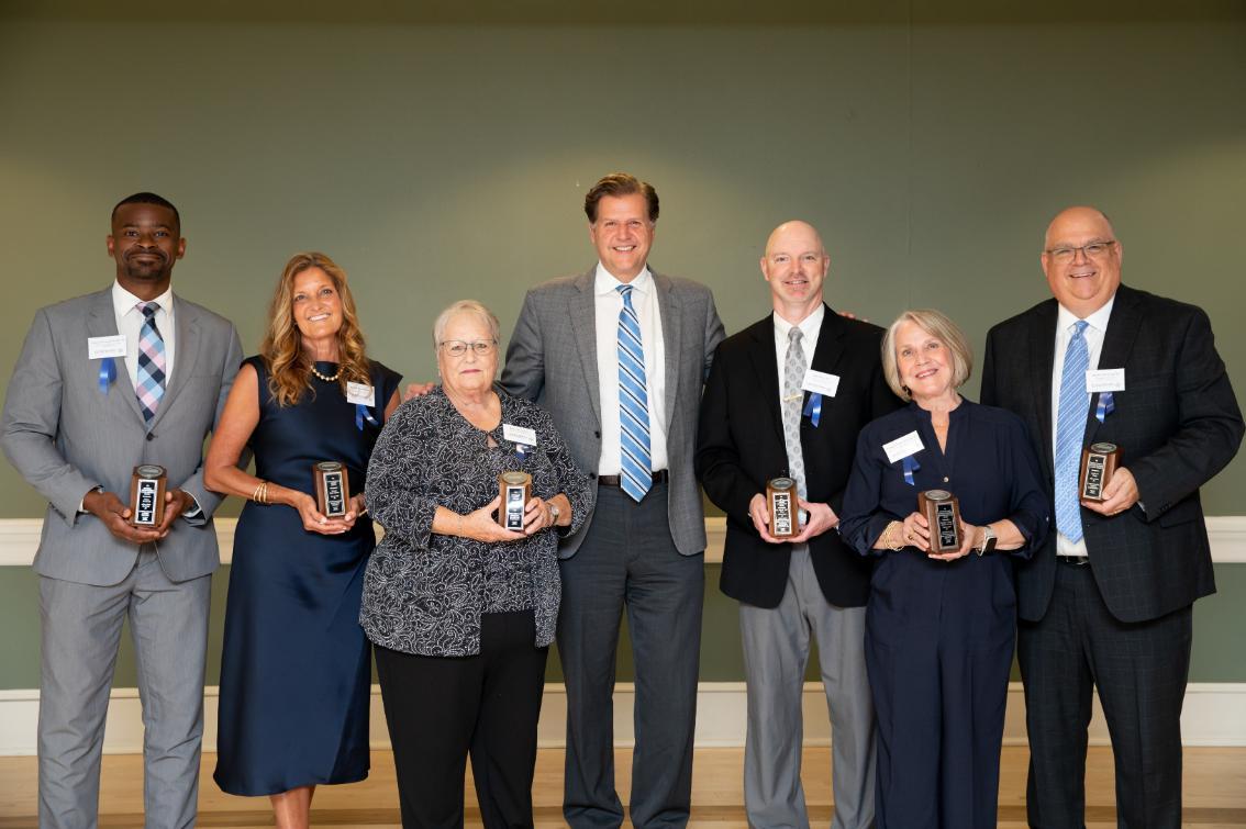 Pictured Left to Right: Cainan Townsend ’15, M.S. ’20; Michele Sims-Gannon ’90; Karen Mitchell Schinabeck, Hon. ’25; President W. Taylor Reveley IV; Dr. Jason “Jake” Milne ’99; Candice “Candy” Jamison Dowdy ’69; and Bradley “Brad” Pomp ’92. Not pictured: Elizabeth Stanton Kostelny ’81.