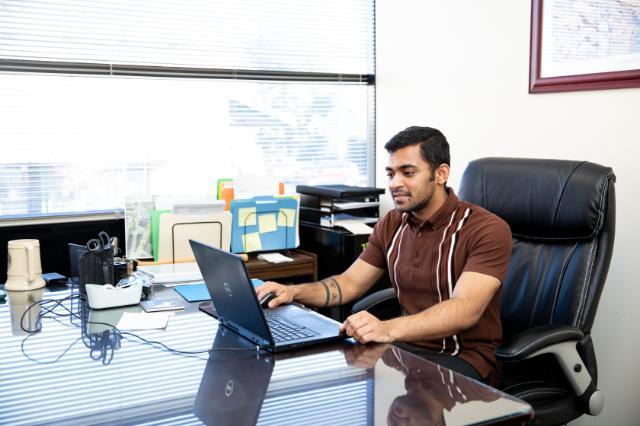Student studying at a laptop