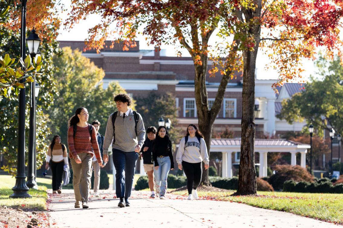 Students walking behind Eason during the fall