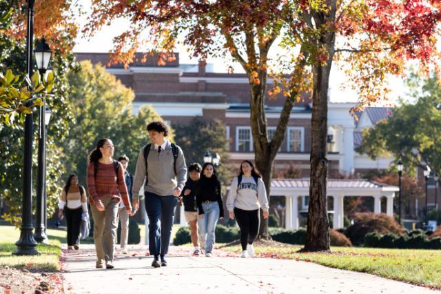 Students walking behind Eason during the fall