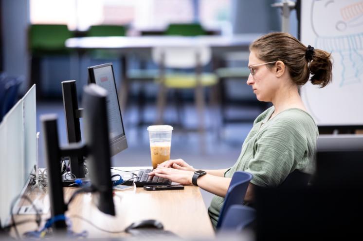 Student studying at a computer in the library