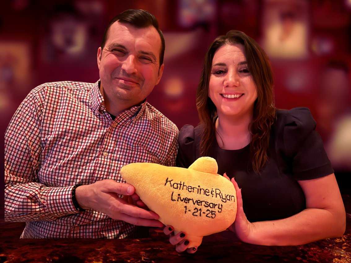 Ryan Buchanan '08 and Katherine Lusk '10 pose together on their one-year liverversary, holding a special, embroidered liver.