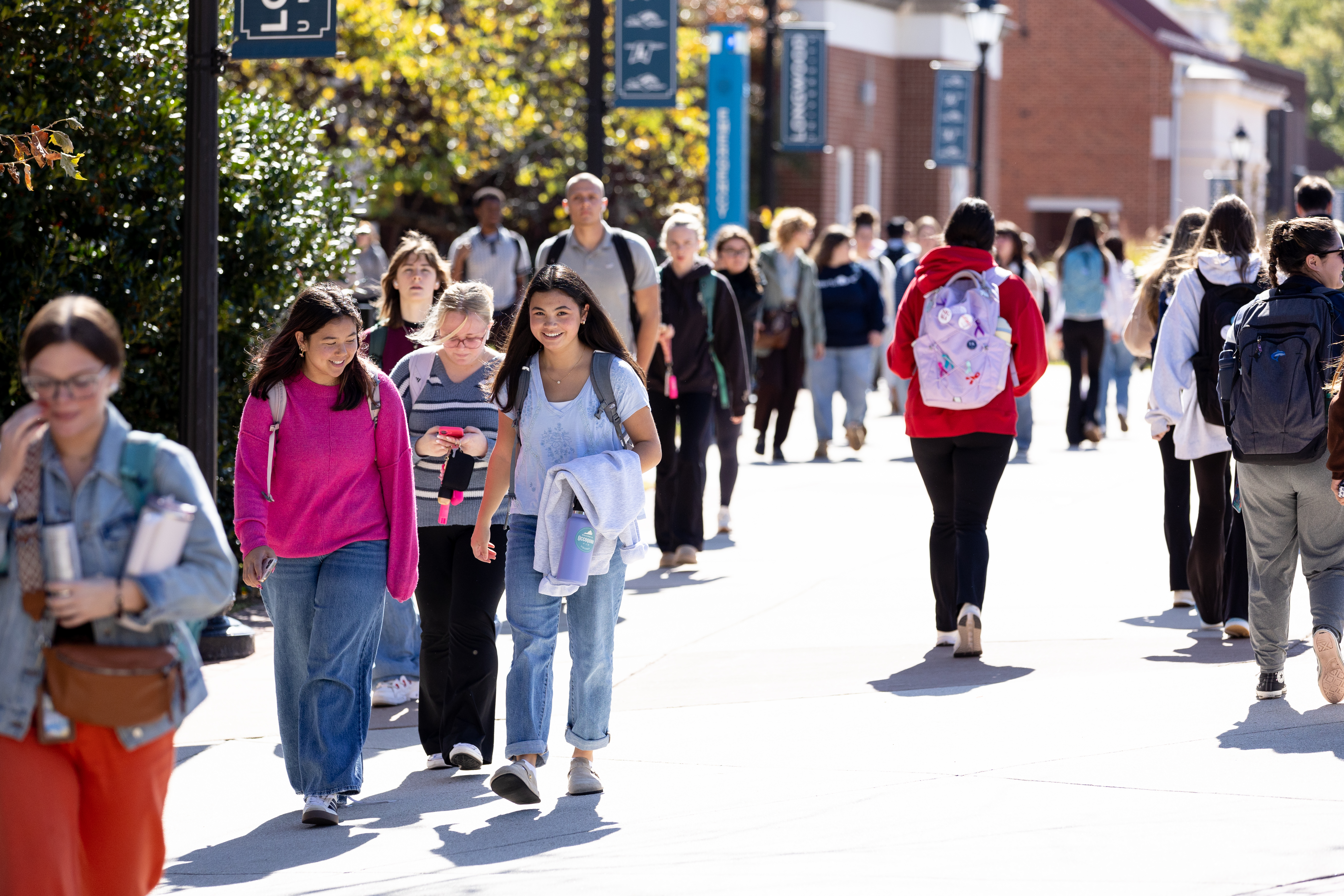 Colorfully dressed students walk down Brock Commons