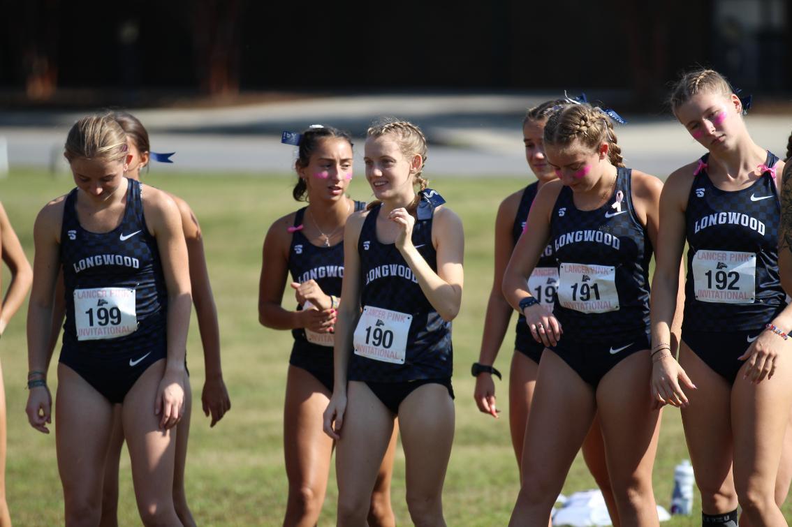 Despite being born with a brain condition, Farley (middle, #190) has become the most decorated cross country runner in school history.
