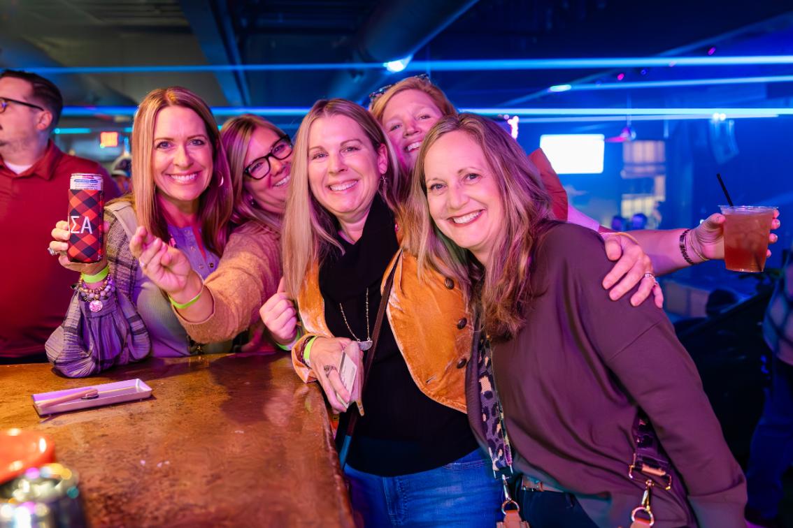 Julie Wiley Ramsey ’93 (second from right, pictured with classmates during an alumni event) describes herself as a 'proud townie' after moving back to Farmville from Virginia Beach in 2022.
